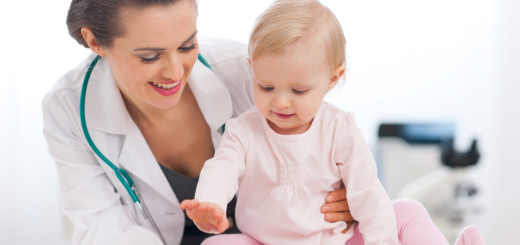 Cheerful baby high five to pediatrician doctor